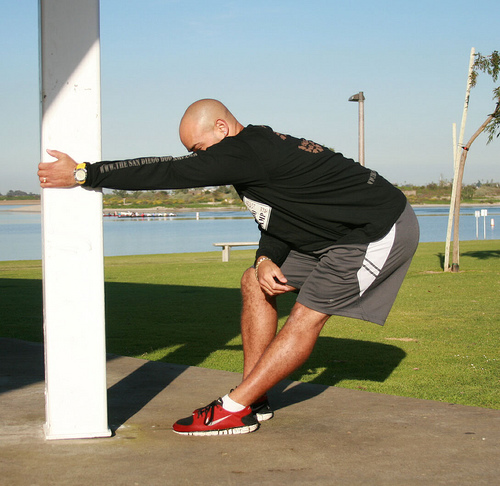 Athlete performing a lat stretch